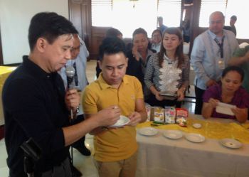 Mr. Mike Palma of UNICEF and Julze Alejandre of NNC demonstrating how to use the rapid test kit to identify if the salt has iodine